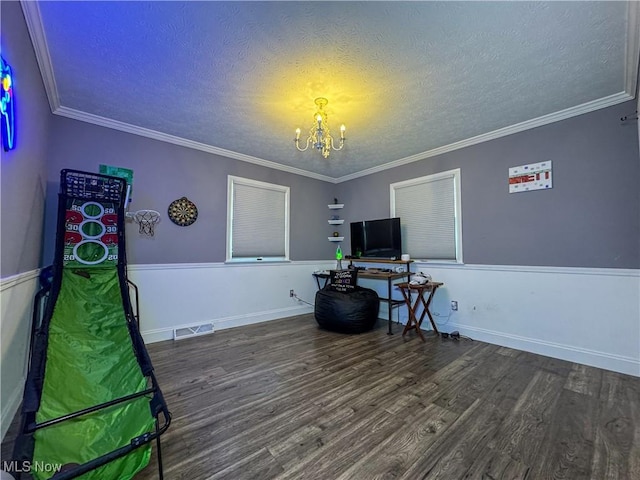 office space with a textured ceiling, visible vents, a chandelier, wood finished floors, and crown molding