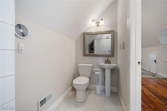 1881 W 65th St, Cleveland, OH 44102 - bathroom with vaulted ceiling, toilet, baseboards, and a sink
