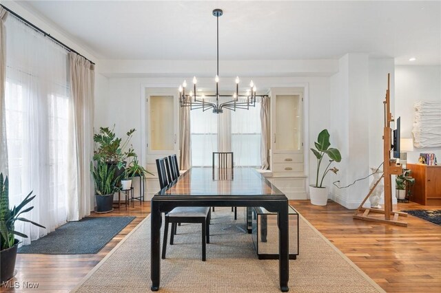 1881 W 65th St, Cleveland, OH 44102 - dining area featuring a chandelier, wood finished floors, healthy amount of natural light, and recessed lighting
