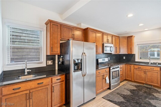 1881 W 65th St, Cleveland, OH 44102 - kitchen featuring appliances with stainless steel finishes, a sink, brown cabinetry, tasteful backsplash, and recessed lighting