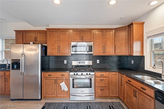 1881 W 65th St, Cleveland, OH 44102 - kitchen featuring stainless steel appliances, a sink, brown cabinetry, and recessed lighting