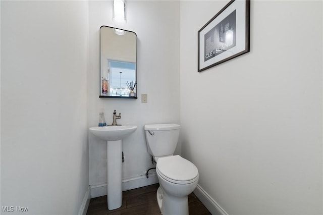 1881 W 65th St, Cleveland, OH 44102 - half bath featuring baseboards, toilet, wood finished floors, and a sink