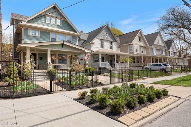 1881 W 65th St, Cleveland, OH 44102 - view of front of property with a porch, a fenced front yard, a gate, and a residential view