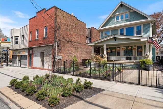 1881 W 65th St, Cleveland, OH 44102 - view of front of house featuring a porch, concrete driveway, a fenced front yard, and an attached garage