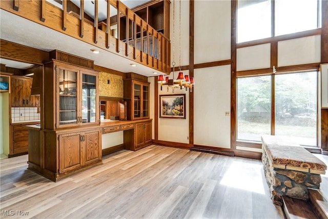 1809 Heritage Cir, Dover, OH 44622 - interior space with a high ceiling, built in desk, light wood finished floors, and baseboards