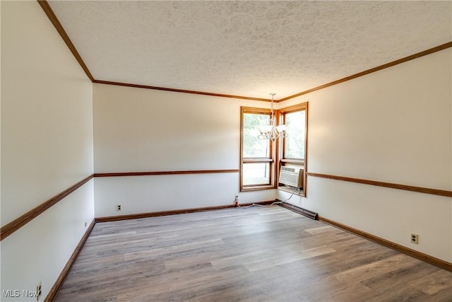1809 Heritage Cir, Dover, OH 44622 - spare room featuring an inviting chandelier, ornamental molding, wood finished floors, and a textured ceiling