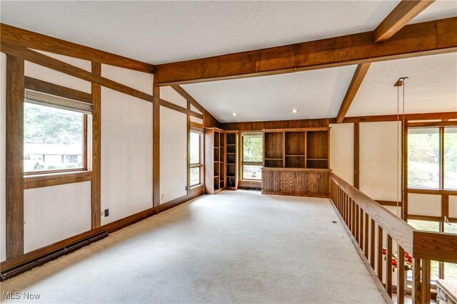 1809 Heritage Cir, Dover, OH 44622 - spare room with light carpet and vaulted ceiling with beams