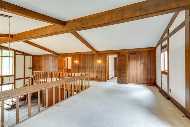 1809 Heritage Cir, Dover, OH 44622 - empty room with wooden walls, plenty of natural light, baseboards, and lofted ceiling with beams