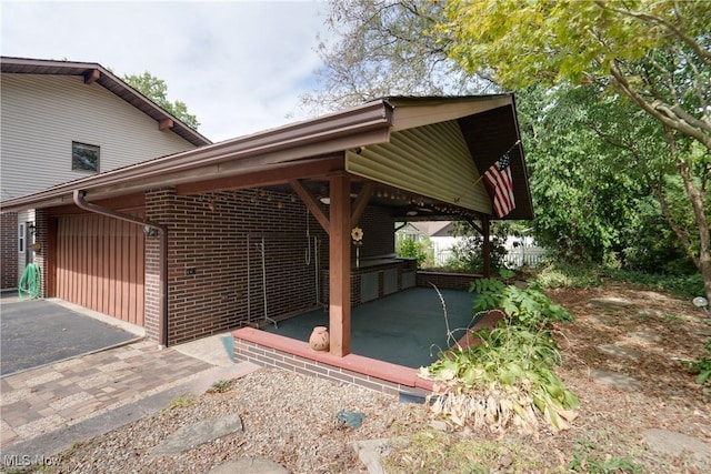 1809 Heritage Cir, Dover, OH 44622 - exterior space featuring brick siding and a patio area