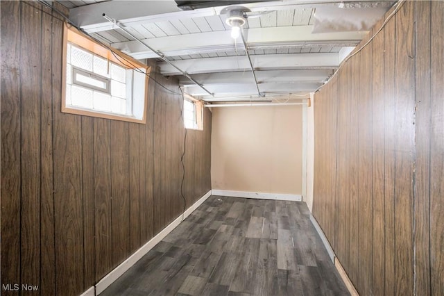 3533 Carlyle Ave, Cleveland, OH 44109 - basement with wooden walls, baseboards, and dark wood-style flooring