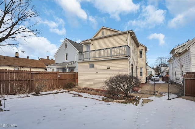 3533 Carlyle Ave, Cleveland, OH 44109 - snow covered house with fence, a gate, and a balcony