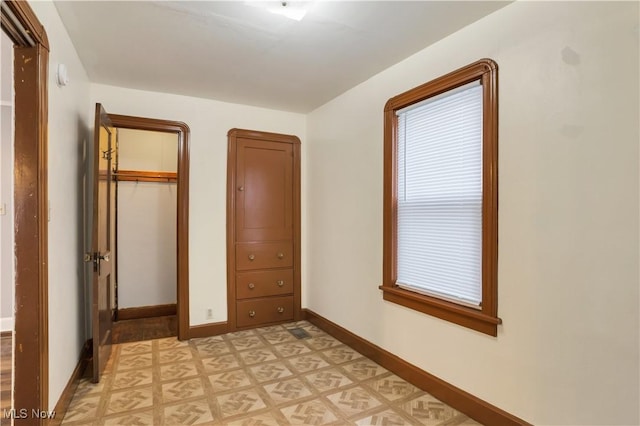 3533 Carlyle Ave, Cleveland, OH 44109 - unfurnished bedroom with light floors, baseboards, and a closet