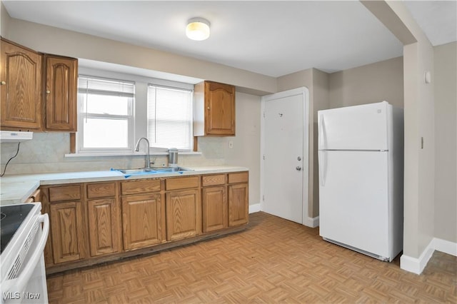 3533 Carlyle Ave, Cleveland, OH 44109 - kitchen with brown cabinets, a sink, and white appliances