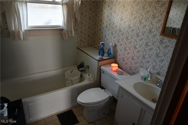 bathroom featuring toilet, vanity, wallpapered walls, and a bathing tub