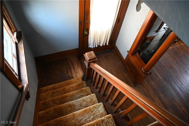 stairs with baseboards and wood finished floors