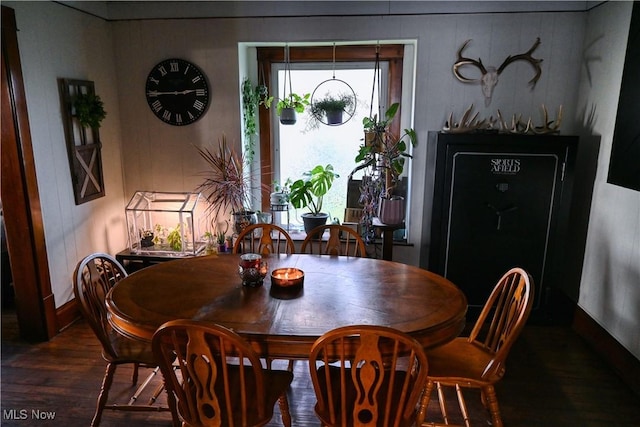 dining space with wood finished floors and baseboards