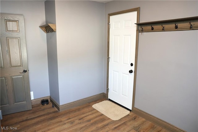 mudroom featuring baseboards and wood finished floors