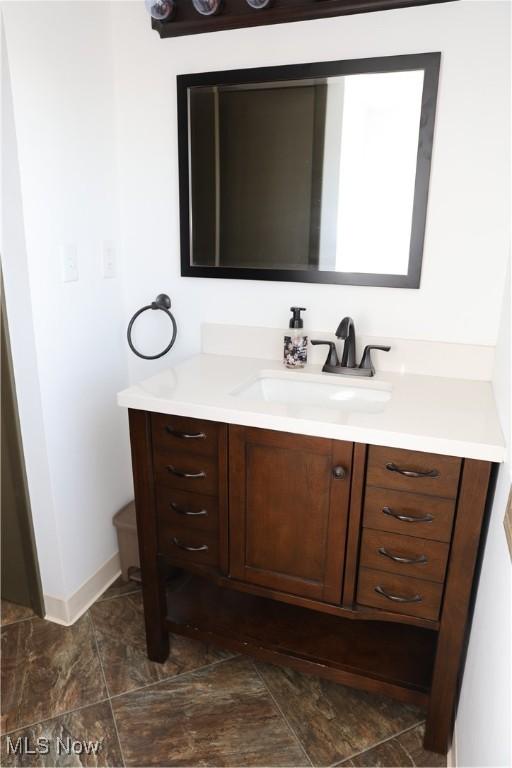 bathroom with baseboards and vanity
