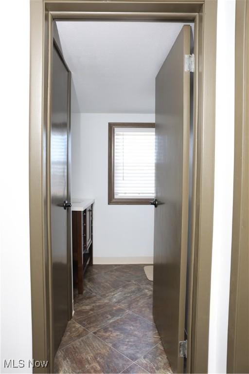 bathroom featuring vanity and baseboards