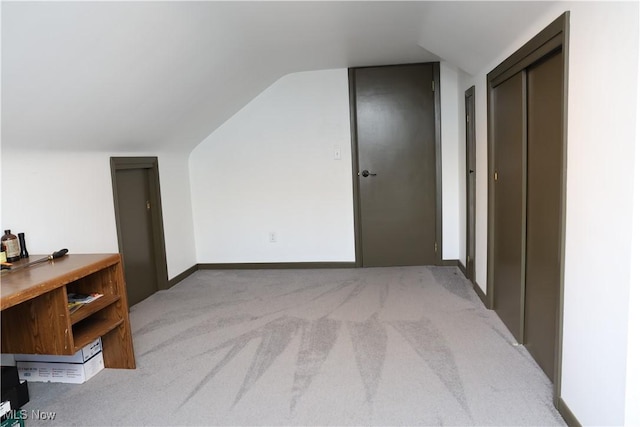 bonus room featuring lofted ceiling and carpet