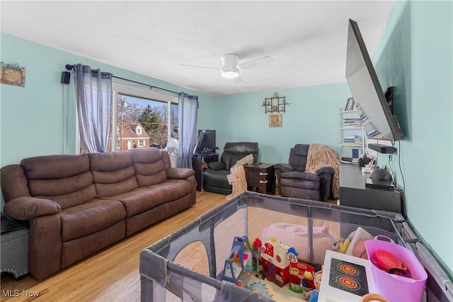 living area with ceiling fan and wood finished floors