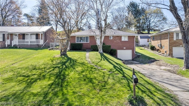 ranch-style home with an attached garage, a front yard, aphalt driveway, and brick siding