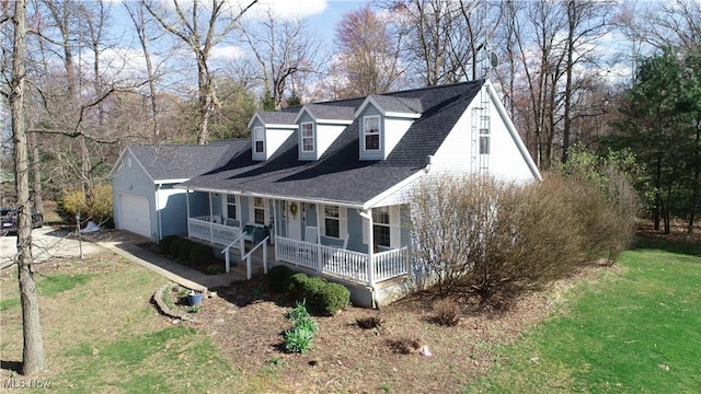 view of front facade featuring driveway, covered porch, an attached garage, a shingled roof, and a front yard