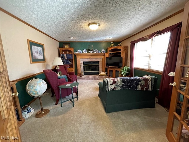 living area featuring crown molding, carpet flooring, a textured ceiling, and a fireplace