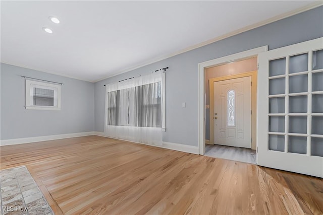 foyer featuring baseboards, ornamental molding, light wood-style floors, and recessed lighting