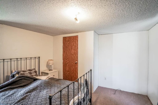 carpeted bedroom with a textured ceiling