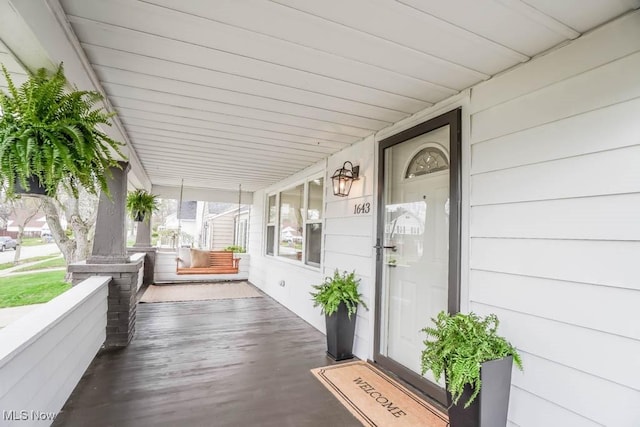 entrance to property featuring a porch