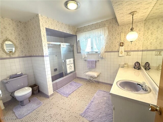 213 Stardust Dr, Wintersville, OH 43953 - full bathroom featuring wallpapered walls, tile walls, wainscoting, vanity, and toilet