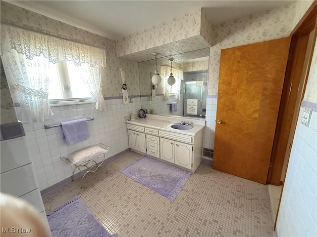 213 Stardust Dr, Wintersville, OH 43953 - bathroom with tile walls, wallpapered walls, vanity, and wainscoting