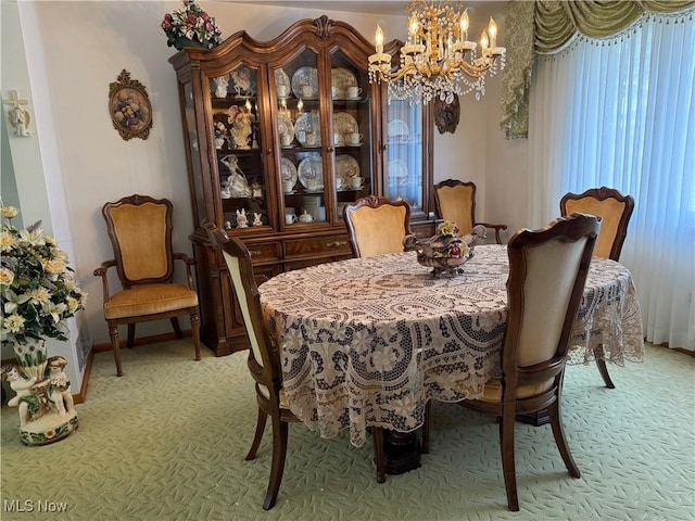 dining area featuring light carpet and an inviting chandelier