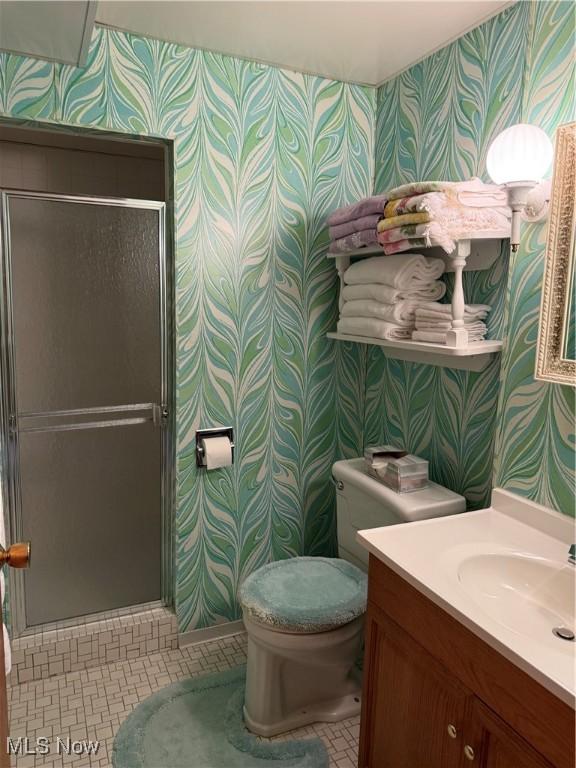 213 Stardust Dr, Wintersville, OH 43953 - bathroom with wallpapered walls, vanity, toilet, a shower stall, and tile patterned flooring