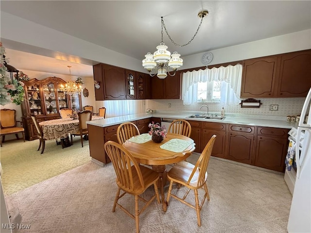 dining area with a chandelier and light colored carpet