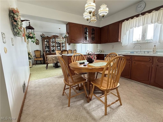 213 Stardust Dr, Wintersville, OH 43953 - dining space featuring a chandelier and light colored carpet