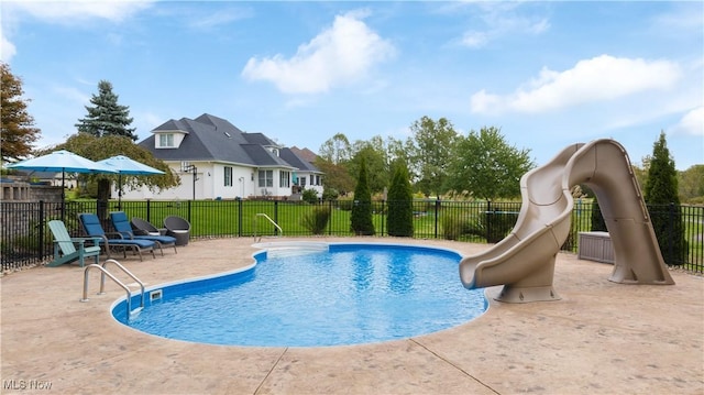 view of swimming pool with a water slide, fence, a patio, and a fenced in pool