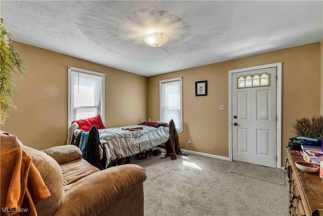 carpeted bedroom featuring baseboards and multiple windows