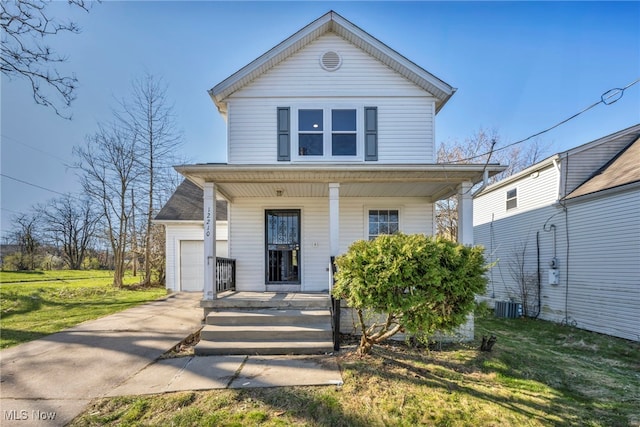view of front of home featuring central air condition unit, driveway, a porch, and a front lawn