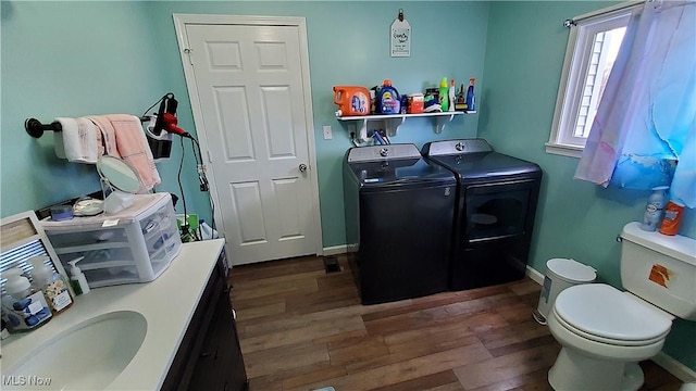 59011 Cherry Hill Rd, Byesville, OH 43723 - bathroom with independent washer and dryer, wood finished floors, toilet, baseboards, and a sink