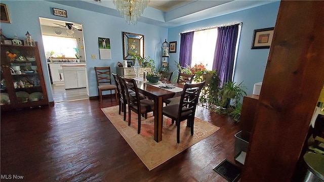 59011 Cherry Hill Rd, Byesville, OH 43723 - dining space featuring dark wood-style flooring, a chandelier, and a raised ceiling