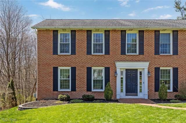 1332 Springbrook Dr, Mansfield, OH 44906 - colonial house with brick siding, a front lawn, and roof with shingles