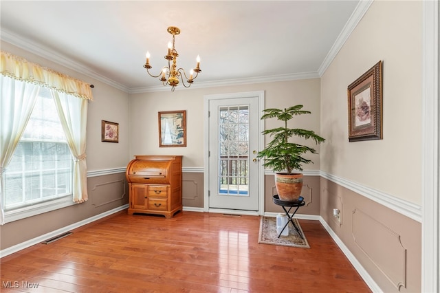 1332 Springbrook Dr, Mansfield, OH 44906 - living area with light wood finished floors, visible vents, a chandelier, and ornamental molding