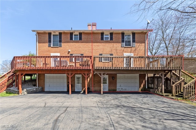 1332 Springbrook Dr, Mansfield, OH 44906 - view of front of property with stairway, driveway, brick siding, and an attached garage