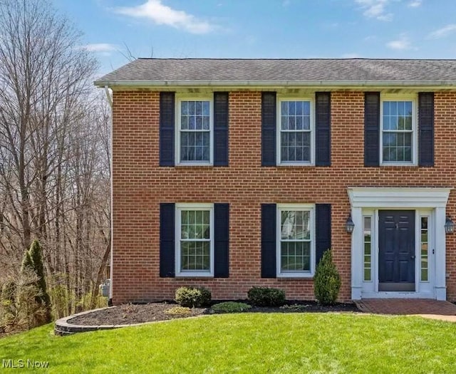 1332 Springbrook Dr, Mansfield, OH 44906 - colonial-style house featuring brick siding, a front lawn, and roof with shingles