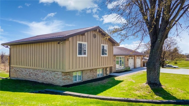 3604 Eldersville Rd, Colliers, WV 26035 - view of property exterior with a lawn, metal roof, board and batten siding, and a garage