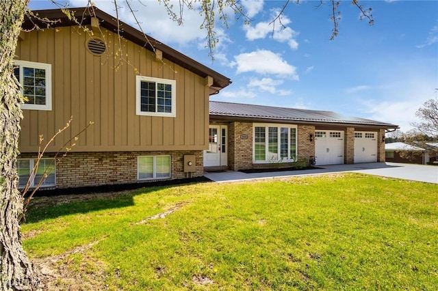 3604 Eldersville Rd, Colliers, WV 26035 - split level home featuring concrete driveway, a front lawn, brick siding, and a garage
