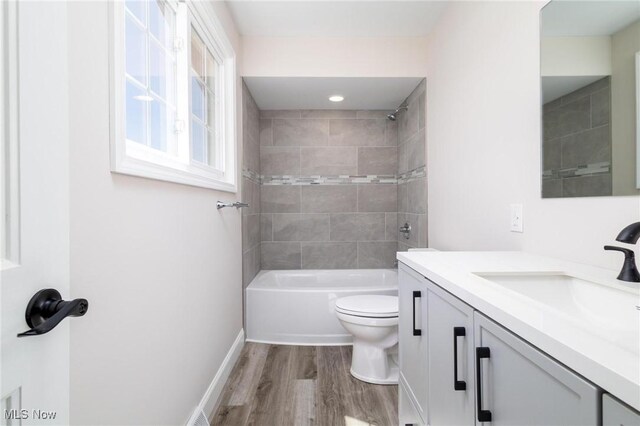 3604 Eldersville Rd, Colliers, WV 26035 - bathroom featuring wood finished floors, toilet, vanity, tub / shower combination, and baseboards