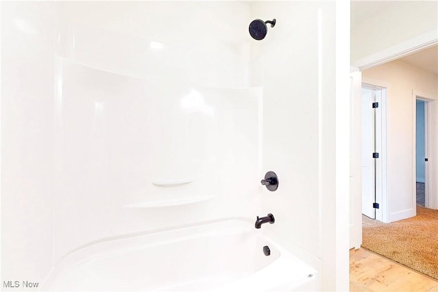 full bathroom featuring baseboards and bathtub / shower combination